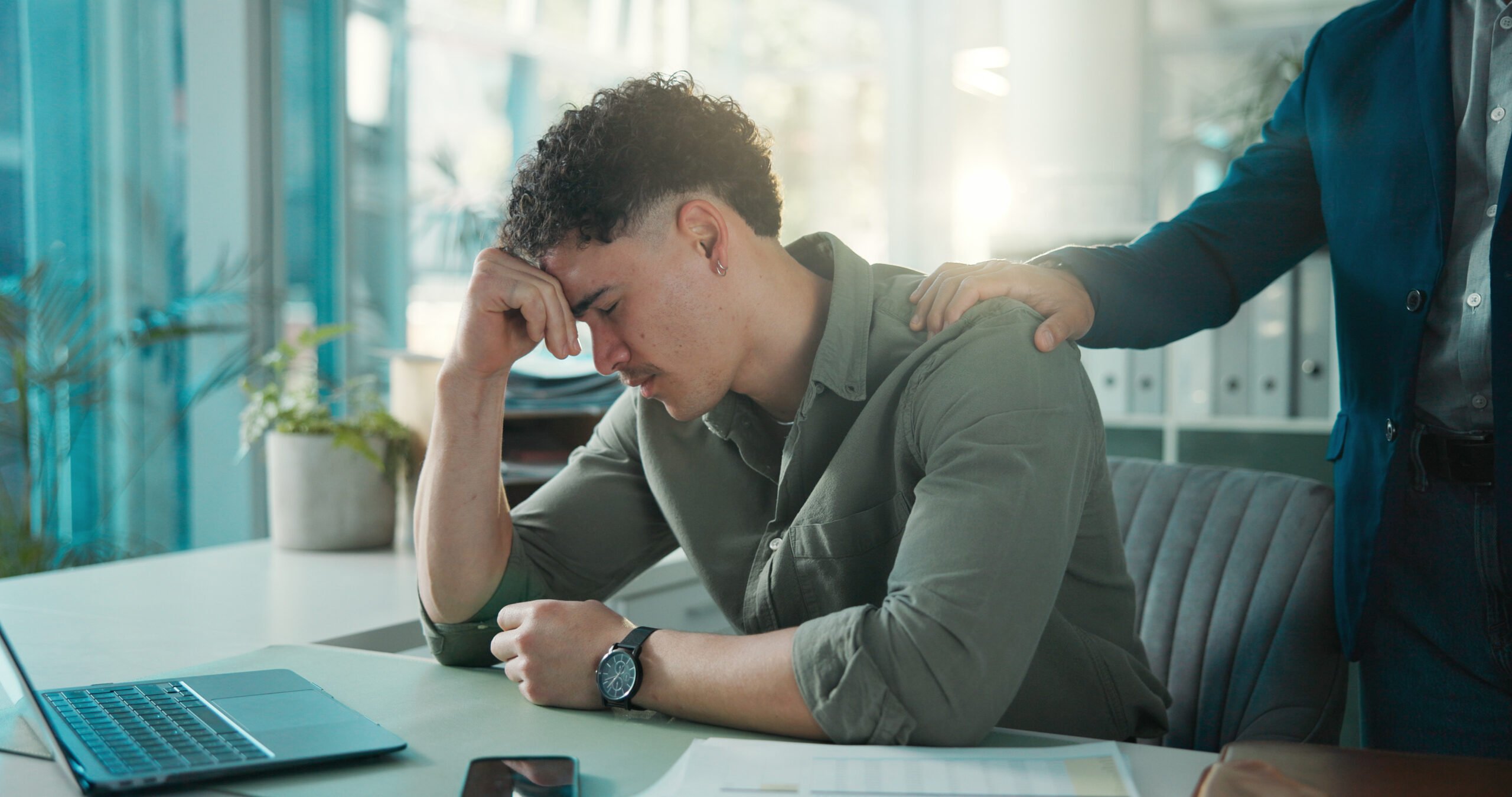 Man, sad and comfort in office, stress and thinking of unemployment, emotional and financial crisis. Employee, unhappy and person with depression for job loss and coworker with empathy for dismissal