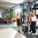 A multicultural group of colleagues in casual attire navigate an airport