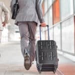 Businessmen with luggage running