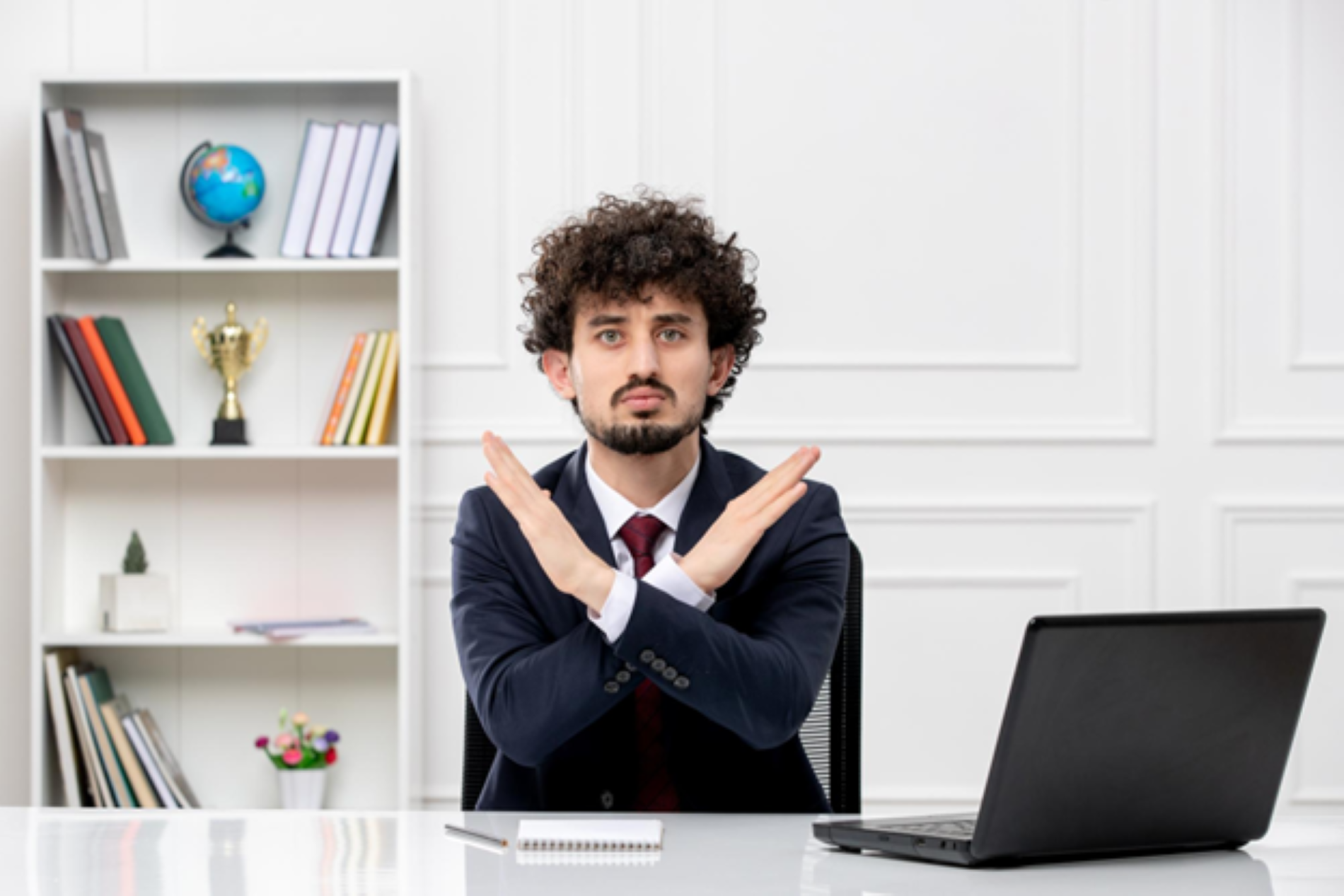 Attorney sitting in front of a desk crossing his arms