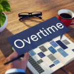 Businessman writing overtime in notebook