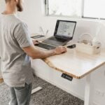 Tall man working in front of a standing desk
