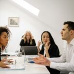 A multi-ethnic team engaged in a heated office discussion