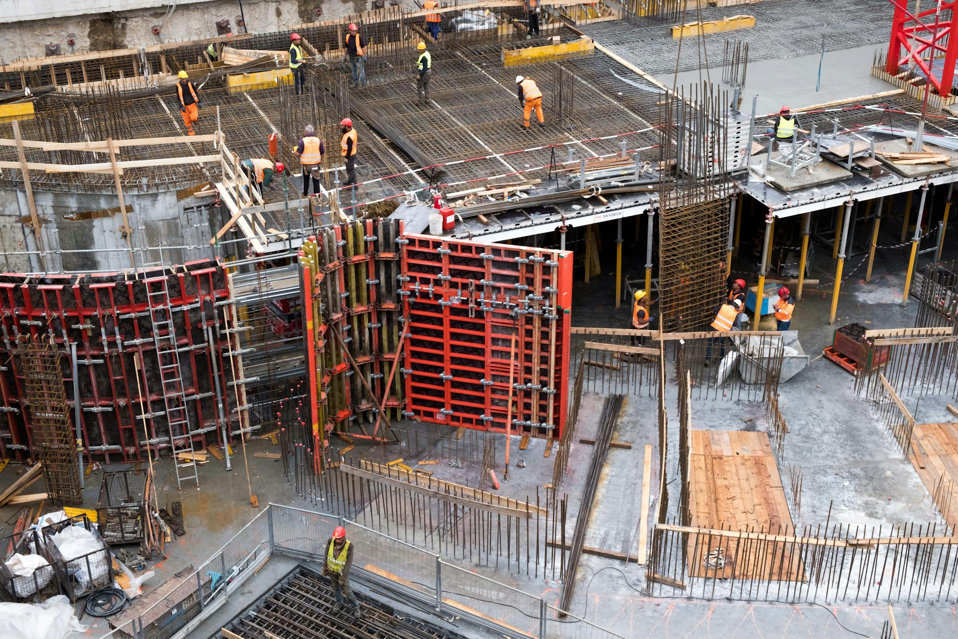 Industrial construction site with workers in high visibility clothing