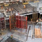 Industrial construction site with workers in high visibility clothing