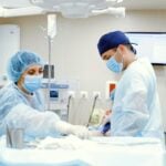 Team of doctors and nurses in an operating room performing surgery