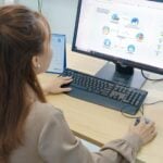 Best HR Software for Large Enterprises and Multinationals Operating in the Middle East in 2026 6 Young woman using desktop computer in office setting