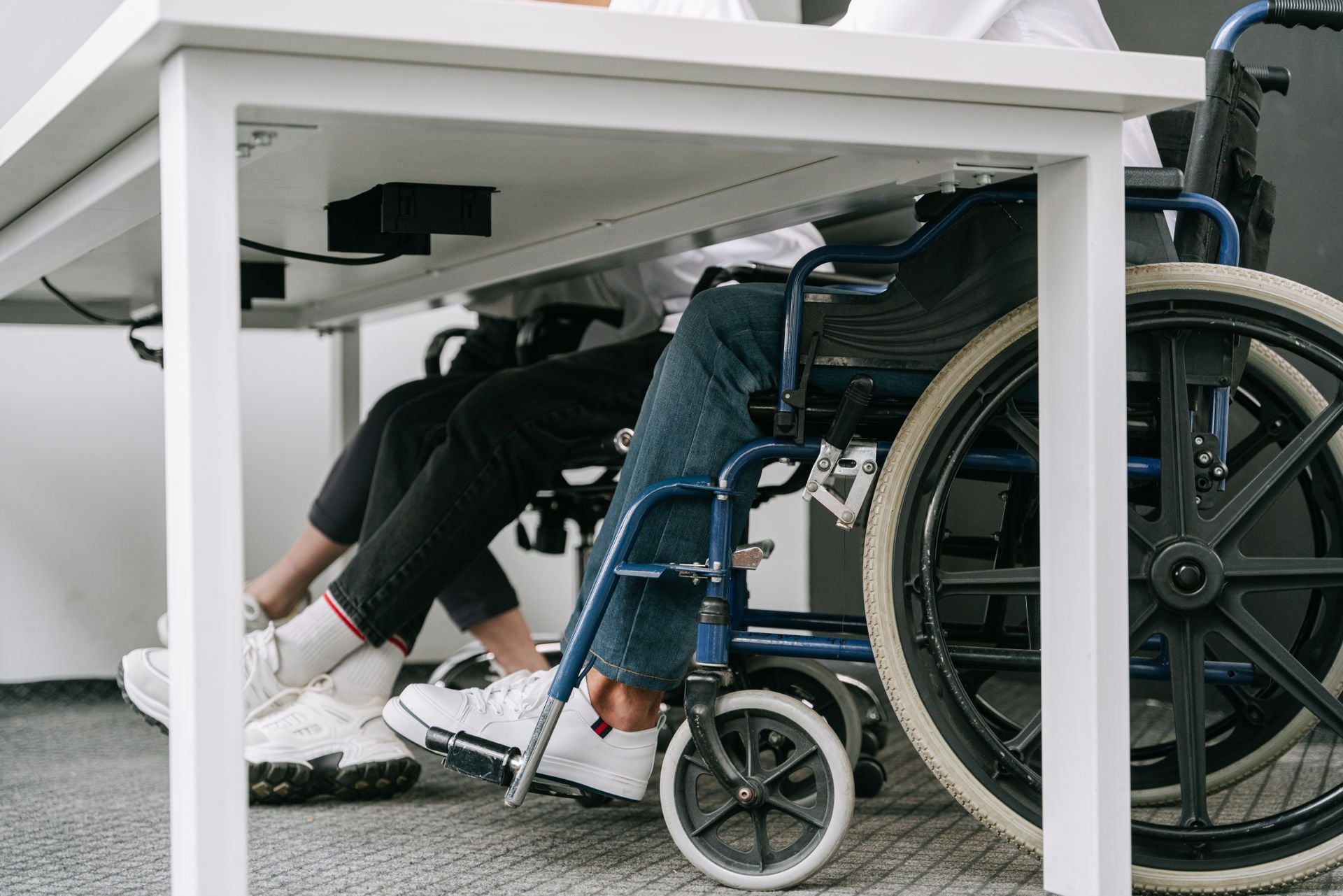 Business setting featuring people working with wheelchair accessibility indoors