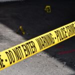 How Criminal Defense Attorneys Prove Negligence in Complex Cases 10 Yellow police crime scene tape marking a restricted urban area on concrete ground