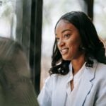 What HR and Legal Professionals Need to Know Before Choosing an Employment Law Dissertation Topic in 2026 10 Professional black woman in business attire smiling during a meeting indoors