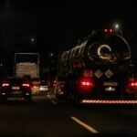 Why Truck Accident Claims Are More Complicated Than Car Accident Claims in Florida 16 Vehicles drive down a dark highway at night, showcasing traffic and car lights