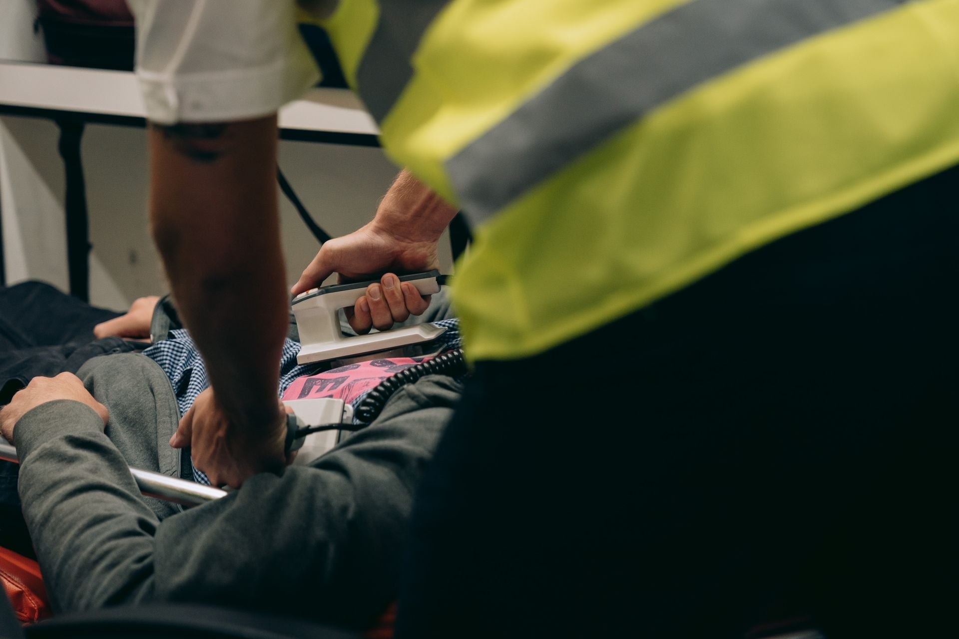 Paramedics provide urgent care to a patient on a stretcher during an emergency situation