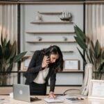 A professional woman lawyer multitasking in a modern office environment, reviewing documents