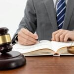 Can You Claim Compensation as a Secondary Victim of Medical Negligence in Ireland? 6 Attorney looking at a book with a gavel in the foreground