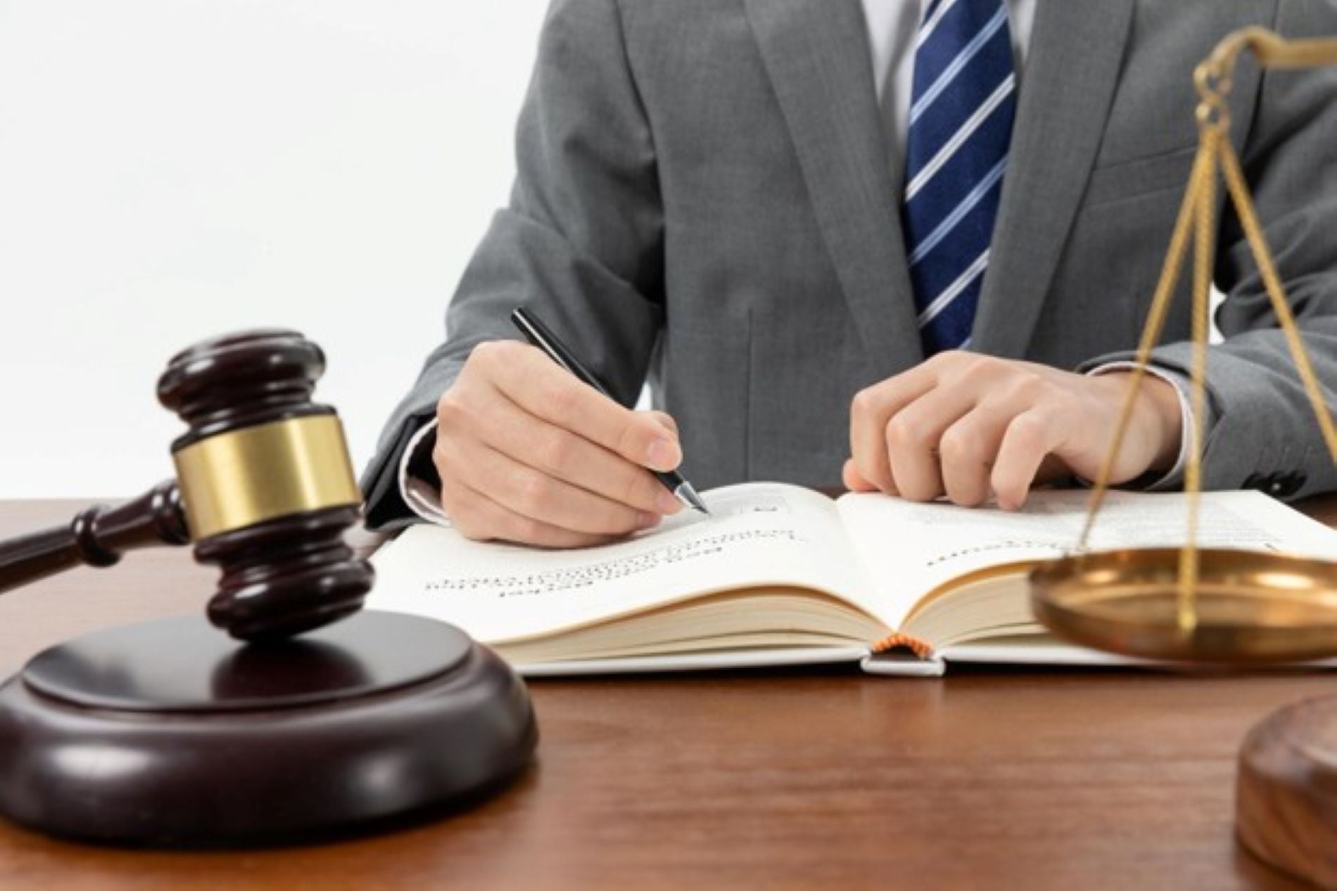 Attorney looking at a book with a gavel in the foreground