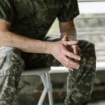 A Guide to Using a Disability Rating Calculator to Assess Your Benefits 7 Close-up of a military veteran's hands in a therapy session