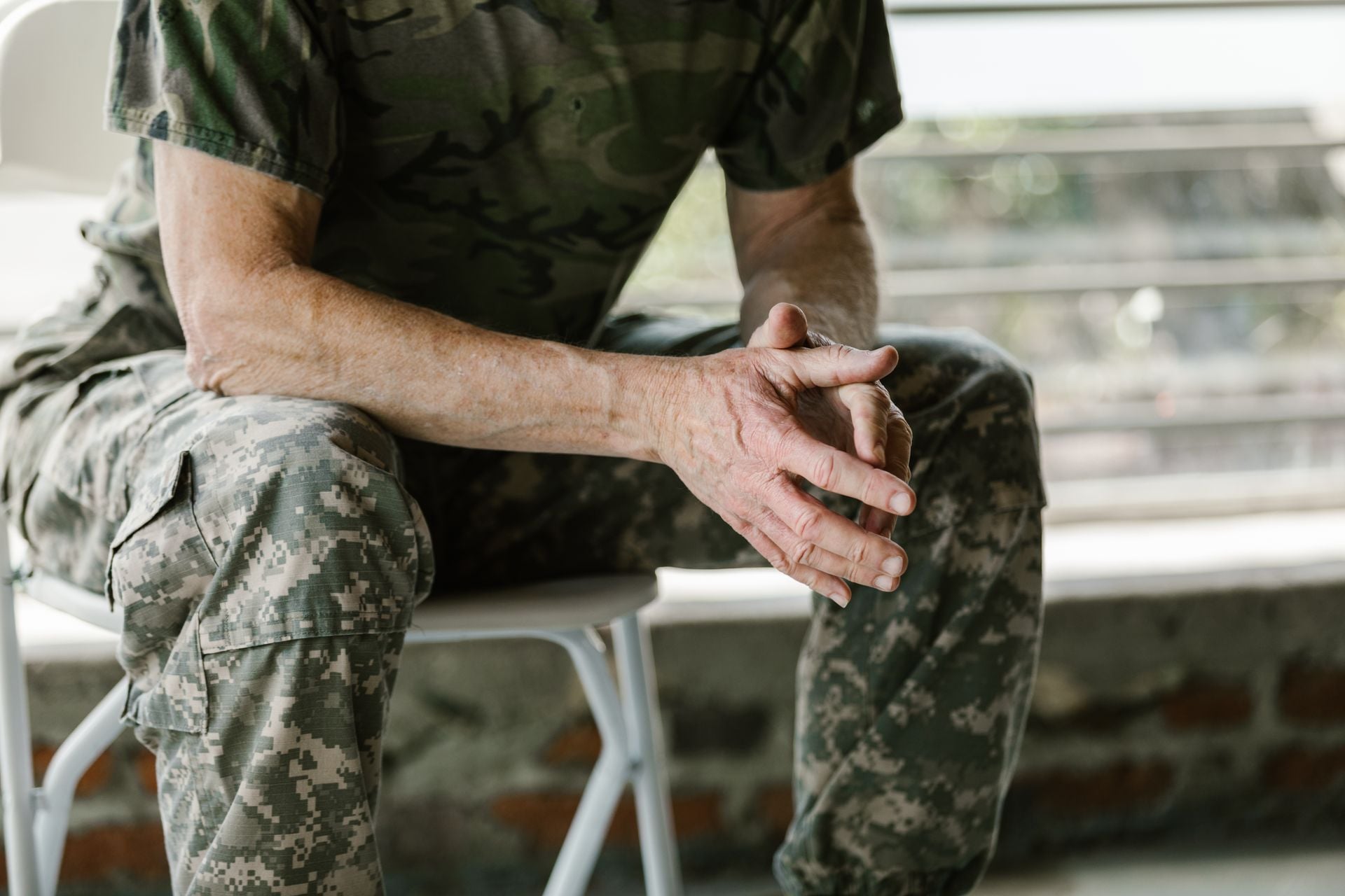 Close-up of a military veteran's hands in a therapy session