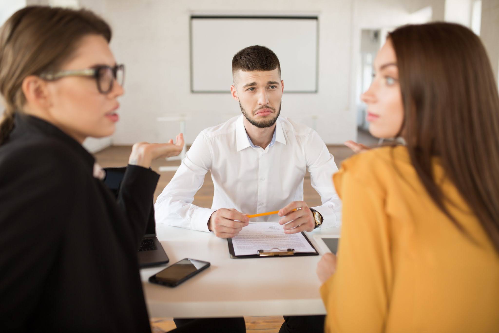 Employees talking around a table