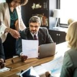How Employers Can Reduce the Risk of Workplace Claims 7 HR professional discussing a document