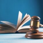 judges gavel and open book on table