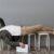 Employee with documents checking time while lying on chairs waiting for work