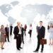 Guessing Game 8 Businessmen standing in front of an earth map