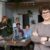 Woman wearing eyeglasses in front of working employees