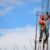 man wearing red hard hat hanged on brown rebar bar
