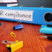 What Types of Sexual Harassment Can You Face at Work? 3 HR compliance is shown on a binder