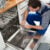 Technician Writing On Clipboard In Kitchen