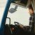 How the Labor Shortage Affects the Auto Industry 2 A man sitting in a truck cabin reading a document inside a blue truck