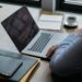 Guessing Game 1 Lawyer using laptop at modern workplace with coffee and documents
