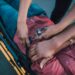 What Types of Sexual Harassment Can You Face at Work? 3 Close-up of a person securing an injured individual on a stretcher, providing emergency care.
