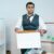 Is Email Sufficient for Official Employment Notices? 5 Professional man organizing office belongings in a cardboard box, preparing for transition